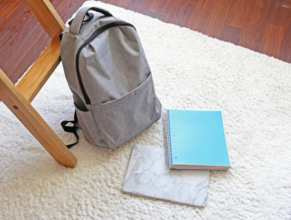 dorm-rug-backpack-notebook-laptop